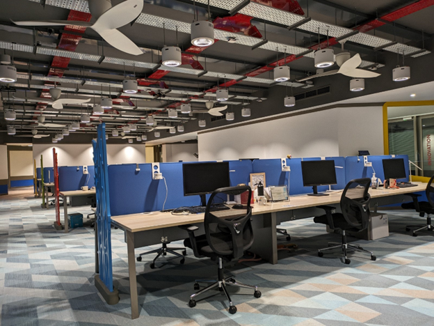 An office space with table setups and chairs.